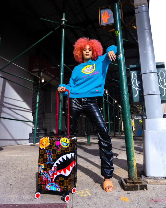 SPRAYGROUND® LUGGAGE GLOBAL MOGUL POPAGANDA RON ENGLISH EDITION HARDSHELL CARRY-ON LUGGAGE